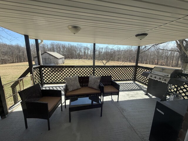 deck featuring a storage unit, an outdoor structure, and a grill