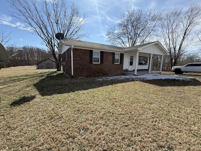 view of front of home featuring covered porch, brick siding, and a front lawn