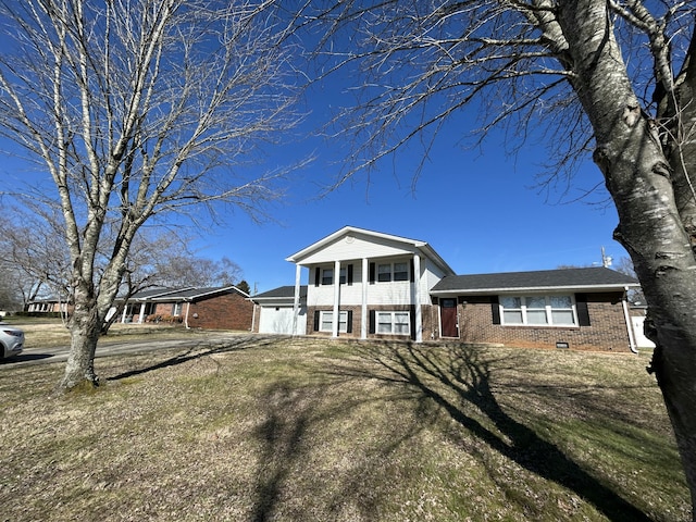 tri-level home with a balcony, a front lawn, and brick siding