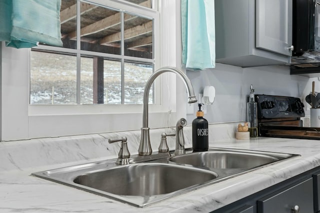 interior details with electric range and a sink