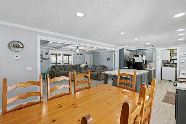 dining space featuring light wood finished floors, recessed lighting, washer / clothes dryer, a ceiling fan, and a textured ceiling