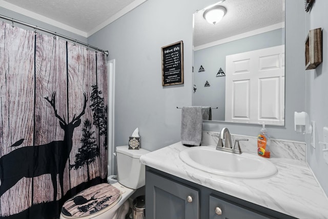 bathroom with a textured ceiling, toilet, vanity, and crown molding