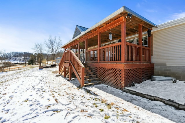 snow covered deck featuring stairway