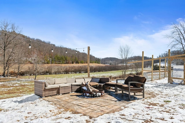 snow covered patio featuring an outdoor hangout area