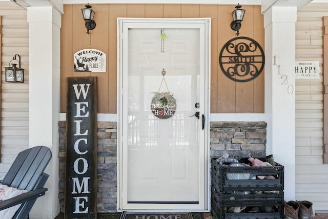 entrance to property with stone siding