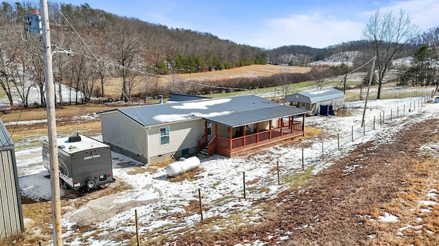 exterior space featuring a porch, crawl space, and metal roof