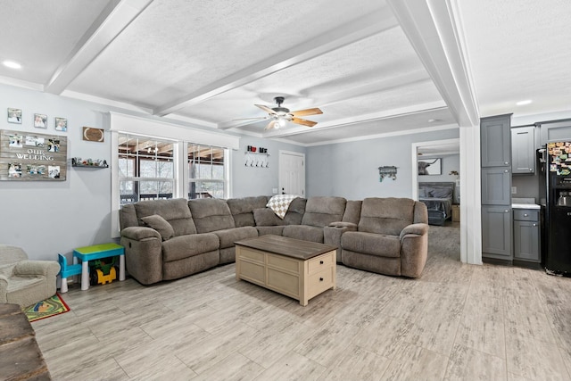 living room featuring recessed lighting, beam ceiling, ceiling fan, and a textured ceiling