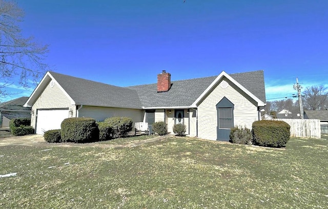 view of front facade featuring a shingled roof, fence, a chimney, and an attached garage