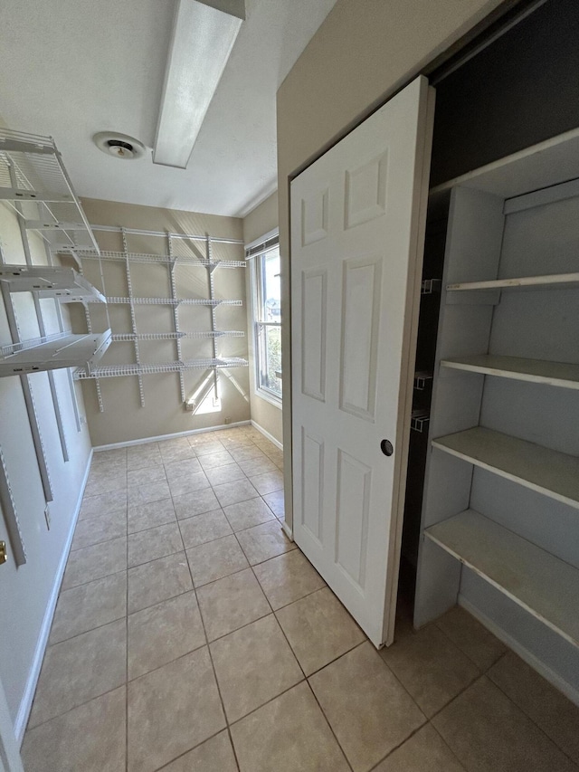 walk in closet with light tile patterned floors and visible vents