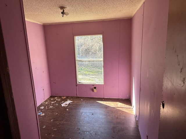 unfurnished room featuring a textured ceiling