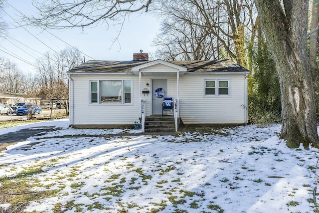 bungalow featuring a chimney