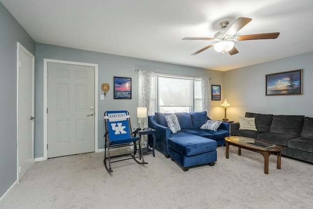 living room featuring light carpet, ceiling fan, and baseboards