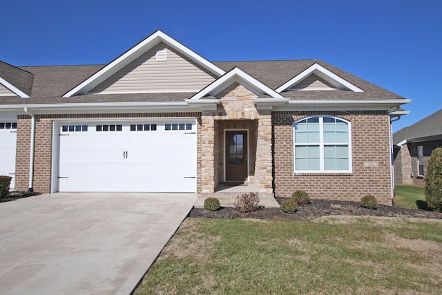 view of front facade with an attached garage, driveway, and roof with shingles