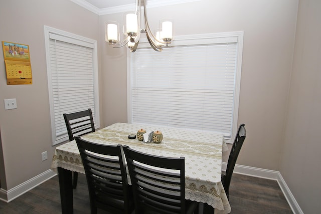 dining space with dark wood-style floors, baseboards, a notable chandelier, and crown molding