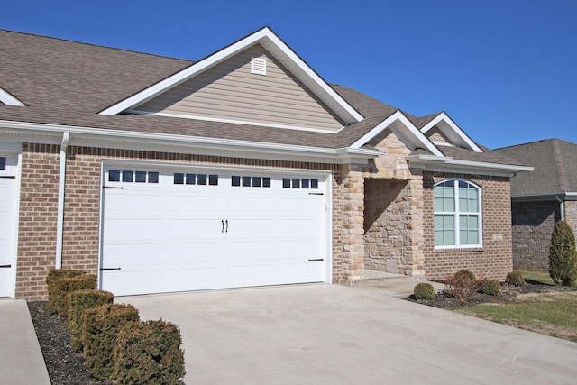 ranch-style house with a garage, stone siding, roof with shingles, and driveway