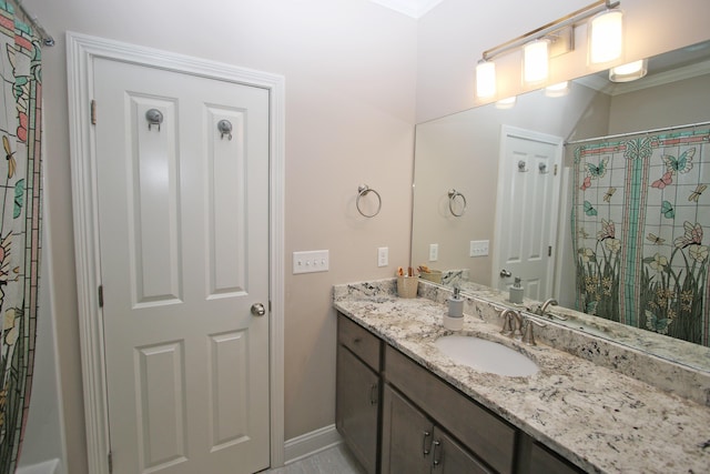 bathroom featuring a shower with shower curtain, vanity, and baseboards