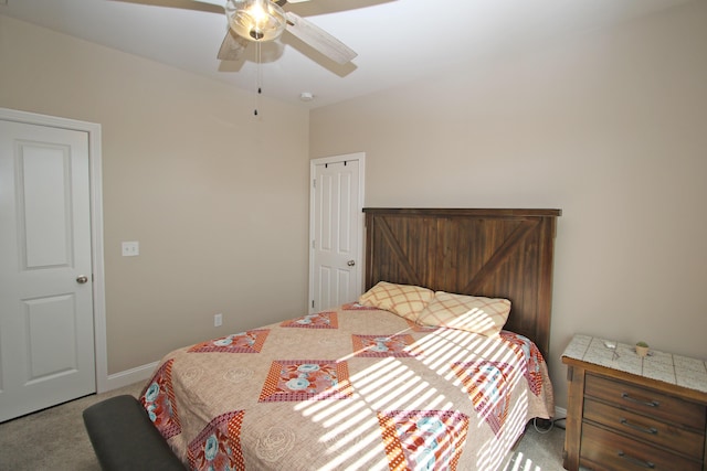 bedroom featuring light carpet, ceiling fan, and baseboards