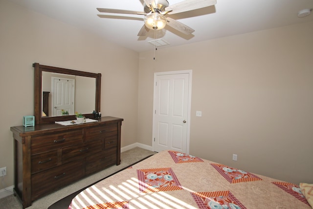 bedroom with light carpet, baseboards, visible vents, and a ceiling fan