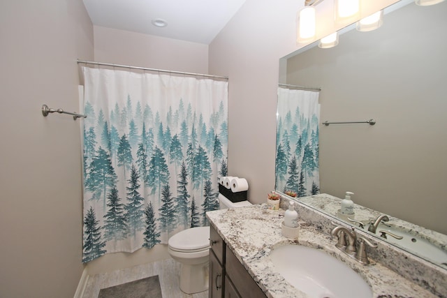 bathroom featuring toilet, a shower with shower curtain, and vanity