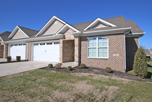 view of front of home with a garage, driveway, brick siding, and a front yard