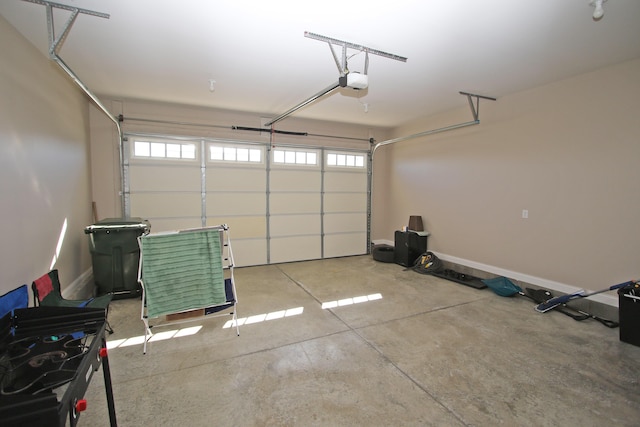 garage with a garage door opener and baseboards