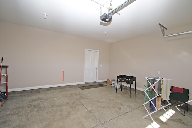 garage featuring baseboards and a garage door opener