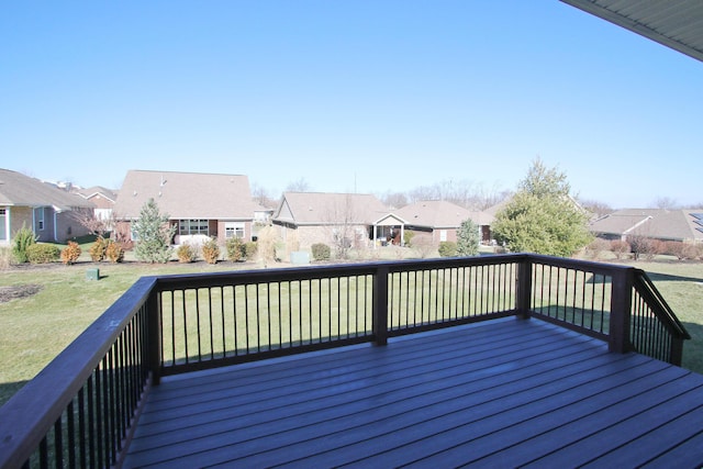 wooden deck featuring a residential view and a yard