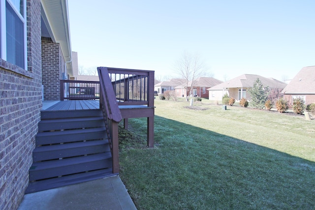 view of yard with a residential view, a wooden deck, and stairs