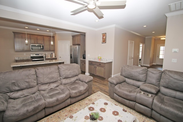 living room featuring recessed lighting, visible vents, dark wood-type flooring, ornamental molding, and baseboards