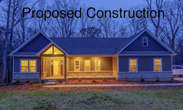 view of front of property with stone siding and a front lawn