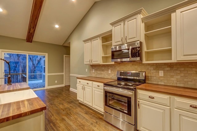 kitchen featuring vaulted ceiling with beams, wooden counters, open shelves, and stainless steel appliances