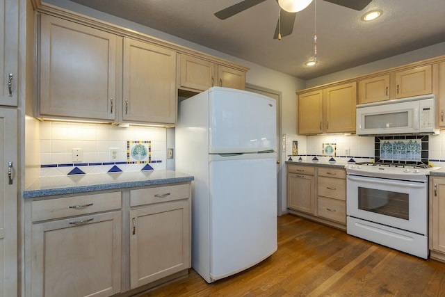 kitchen with a ceiling fan, white appliances, light brown cabinets, and dark wood-type flooring