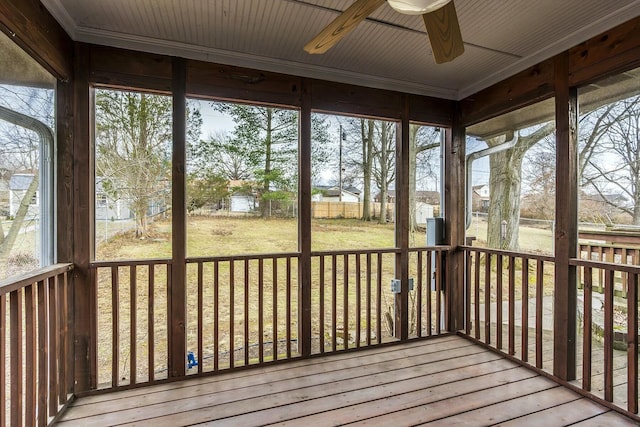 unfurnished sunroom featuring a wealth of natural light and ceiling fan