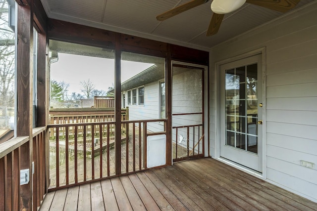 unfurnished sunroom featuring a ceiling fan
