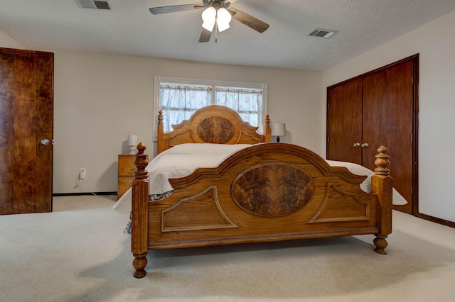 carpeted bedroom featuring baseboards, visible vents, ceiling fan, a textured ceiling, and a closet