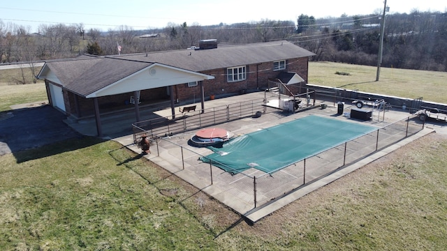 view of pool featuring a fenced in pool, a patio area, a yard, and fence