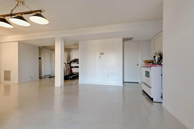 unfurnished room with baseboards and visible vents