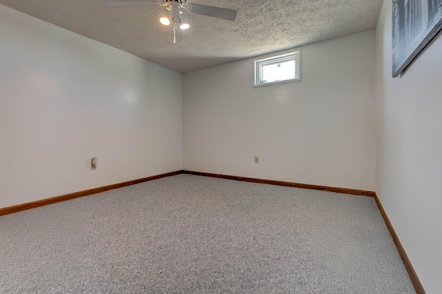 carpeted empty room featuring ceiling fan, a textured ceiling, and baseboards