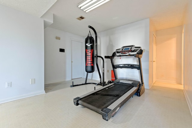 workout area with visible vents and baseboards