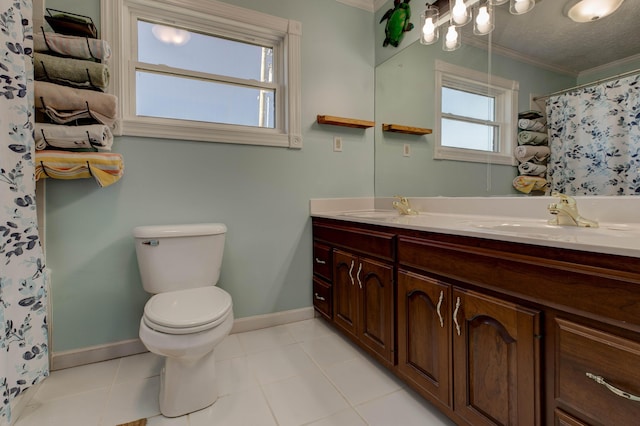 full bathroom featuring crown molding, a sink, toilet, and double vanity