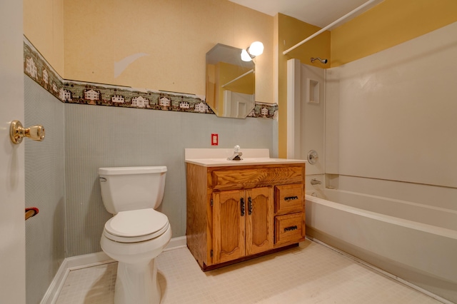 bathroom with washtub / shower combination, vanity, and toilet