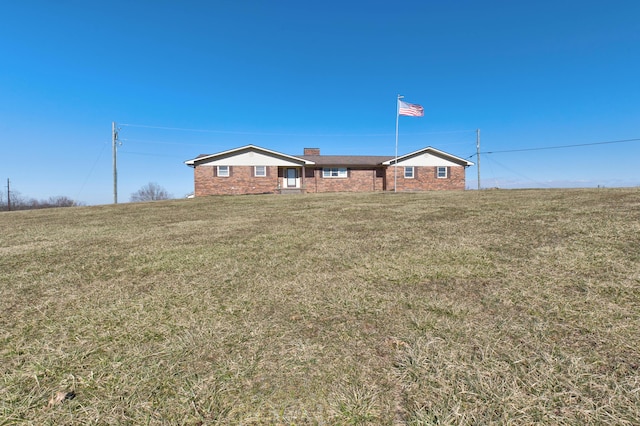 ranch-style home with a front lawn and brick siding