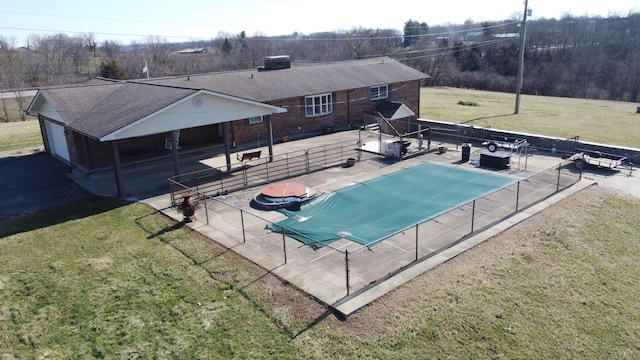 view of swimming pool with a patio area, a fenced in pool, fence, and a lawn