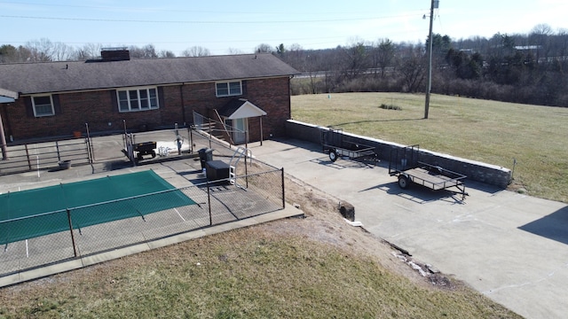 view of pool featuring a patio area, fence, a fenced in pool, and a yard