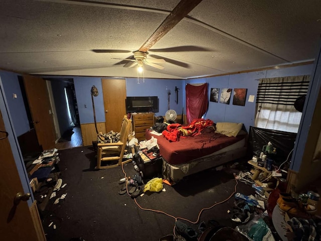 bedroom featuring vaulted ceiling, a textured ceiling, and ceiling fan