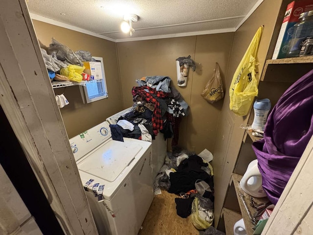 washroom featuring a textured ceiling, laundry area, washer / clothes dryer, and crown molding