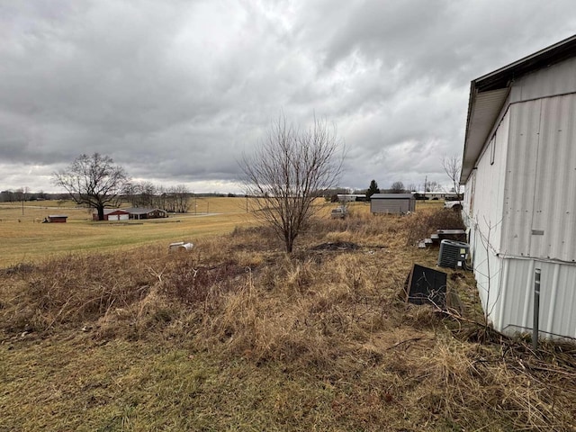 view of yard with a rural view and cooling unit