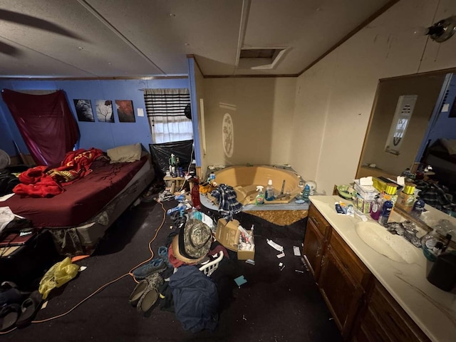 bedroom with ornamental molding, attic access, and a sink