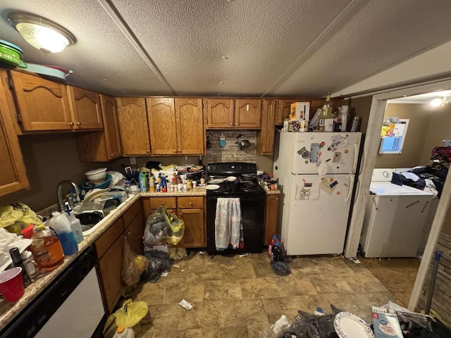 kitchen with washer / clothes dryer, light countertops, brown cabinetry, freestanding refrigerator, and black / electric stove