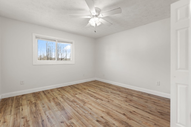 unfurnished room featuring a ceiling fan, light wood-type flooring, a textured ceiling, and baseboards